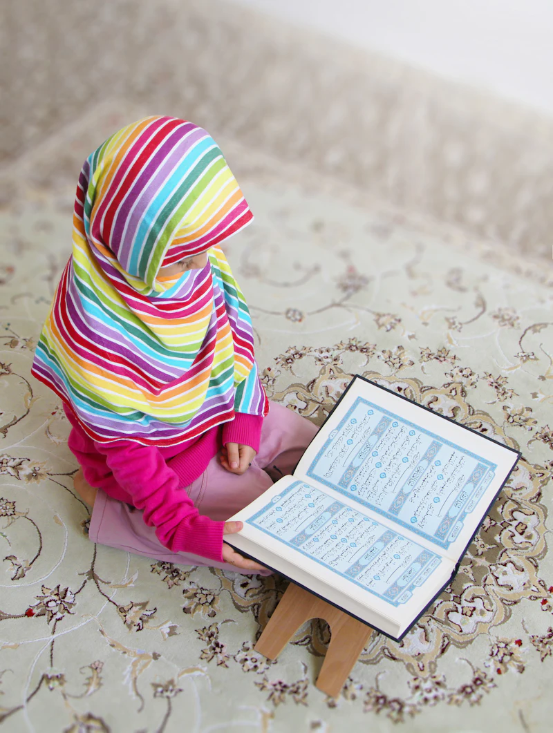 Young girl reading the Quran