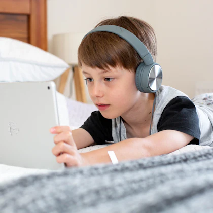 Boy with headphones in an online Quran class